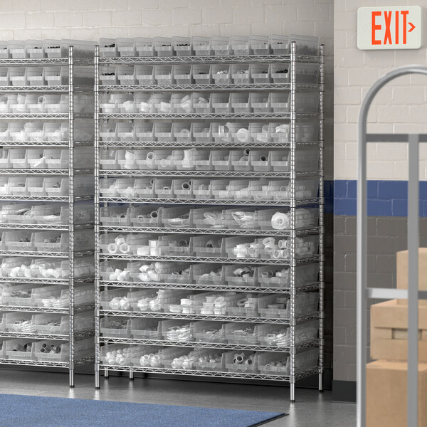 A Regency metal wire shelving unit with clear plastic bins on it.