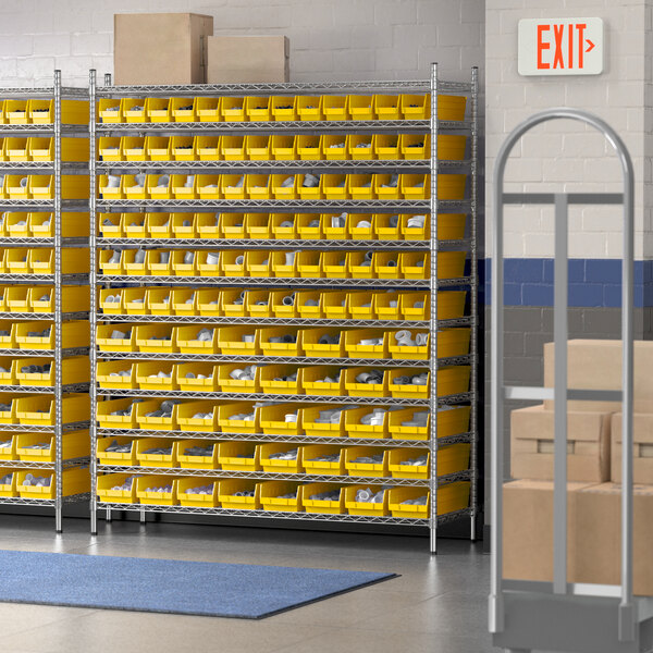 A Regency wire shelving unit with yellow bins on each shelf.