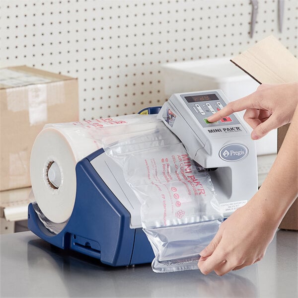 A person using a Pregis AirSpeed Mini Pak'r machine to fill a plastic bag with air cushions.