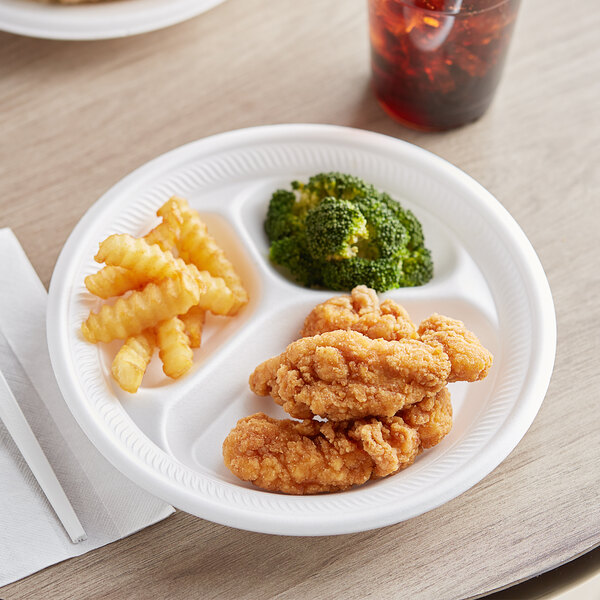 A 9" white non-laminated foam plate with chicken nuggets and fries on it.