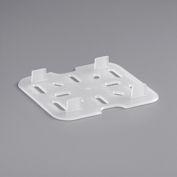 A white plastic Vigor drain tray with four holes.
