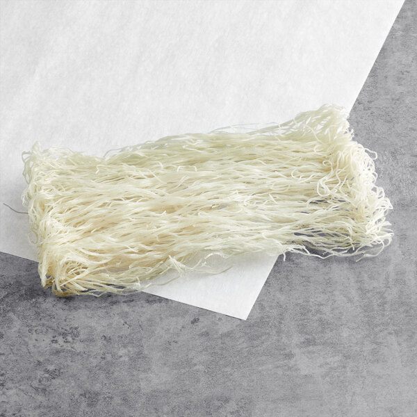 A close-up of Excellent Bihon noodles on a white surface.