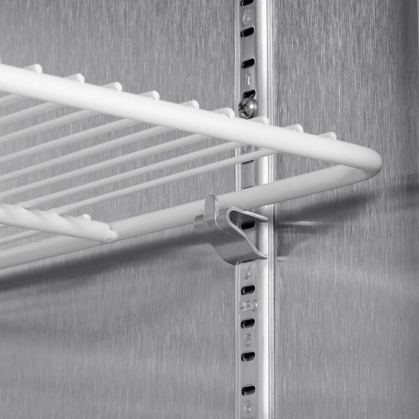 A metal shelf with metal rods inside a Beverage-Air stainless steel reach-in freezer.