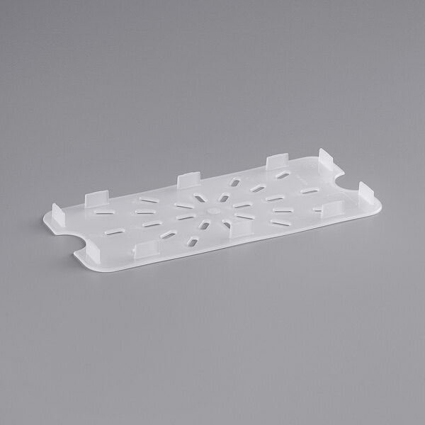 A white plastic tray with holes.