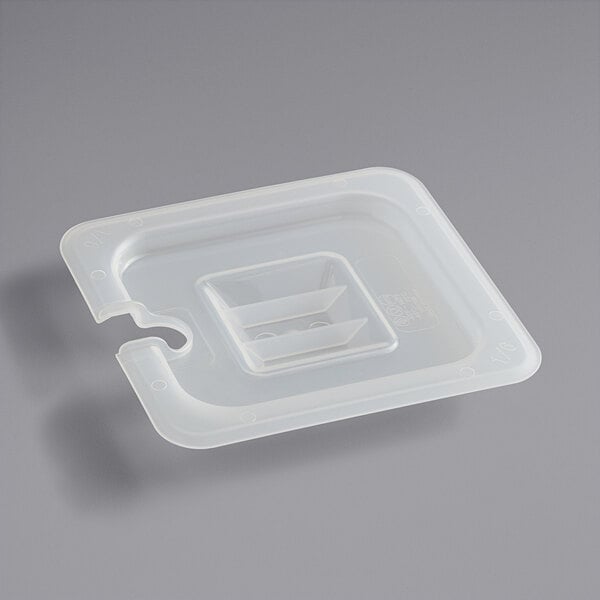 A close-up of a translucent plastic container with a handled lid and notch in the middle.