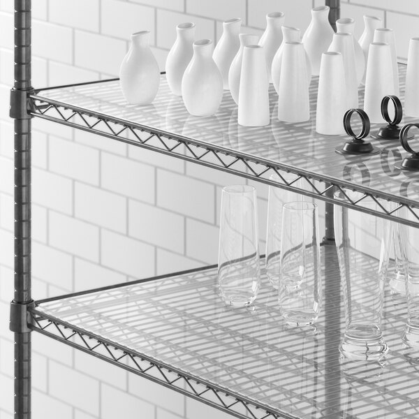 Clear PVC shelf liner on a Regency shelf holding white vases and glasses.