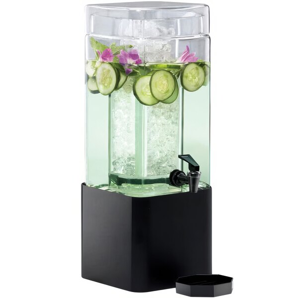 A Cal-Mil square plastic beverage dispenser with a black metal base filled with water, ice, and cucumber slices.