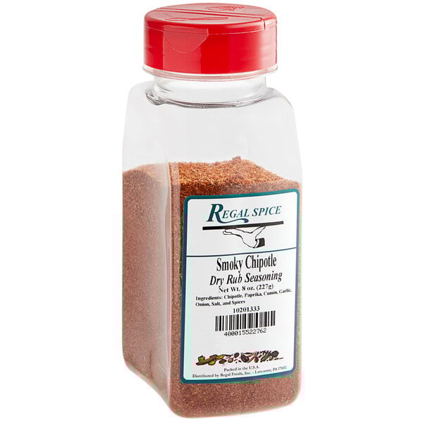 A clear container of Regal Smoky Chipotle Dry Seasoning Rub with red powder inside.