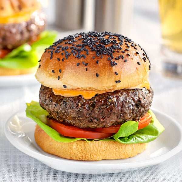 A burger on a plate seasoned with Regal Hamburger Seasoning.