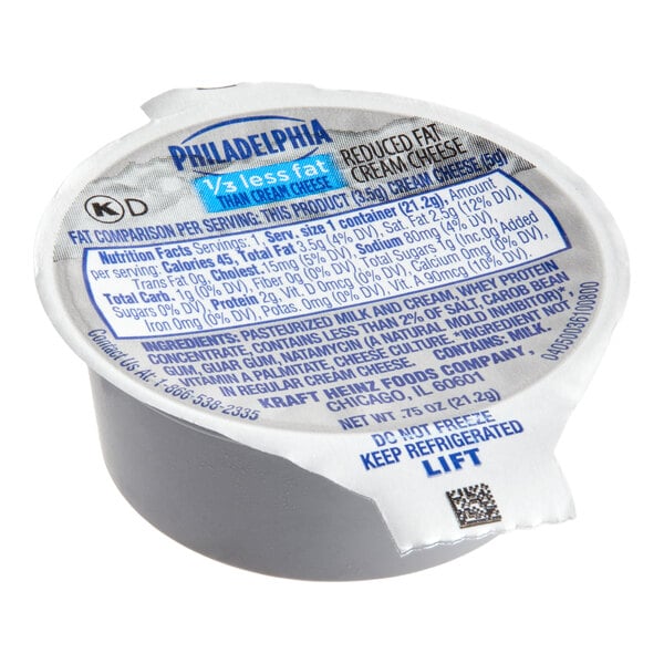 A single-serve portion cup of Philadelphia Reduced Fat Cream Cheese Spread.