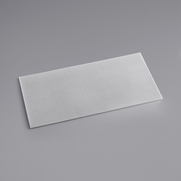 Two white rectangular aluminum eggcrate louvers on a gray surface.