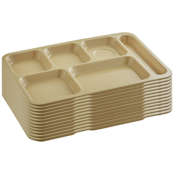 A stack of 12 tan melamine trays with six compartments.