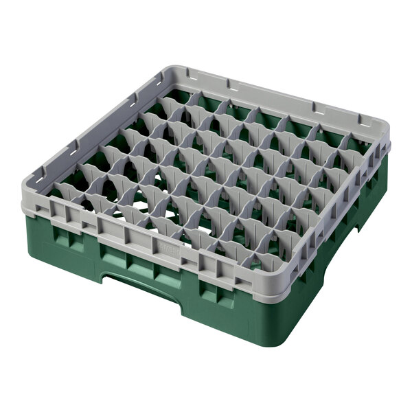 A green plastic Cambro glass rack with grey compartments.