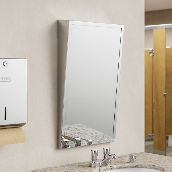 A stainless steel framed American Specialties, Inc. plate glass mirror above a sink.