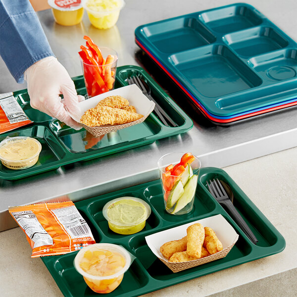 A Choice forest green melamine compartment tray with food and a fork in it.