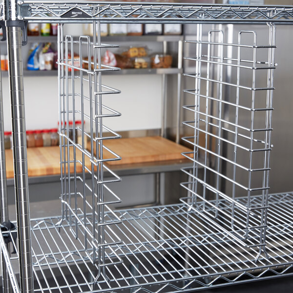 Metro chrome tray slides on a metal rack in a kitchen.