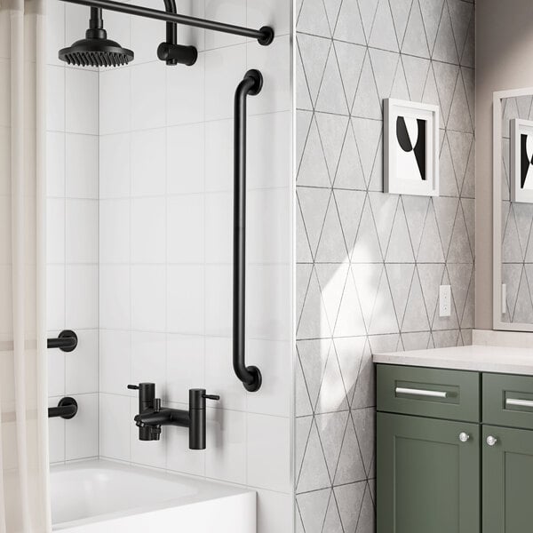 A 36-inch matte black grab bar with a snap flange installed vertically on a bathroom wall.