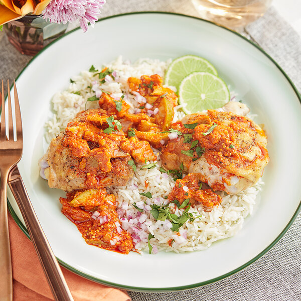 A plate of food with Ashoka Mango Pickle on it next to a fork and knife.