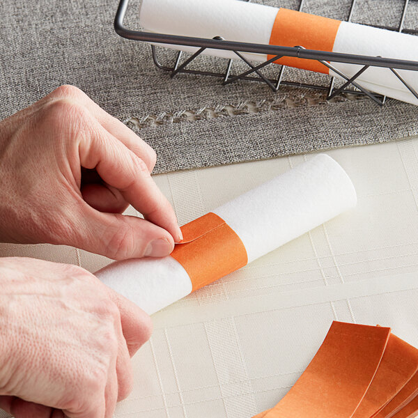 A person using Rust self-adhering paper napkin band.