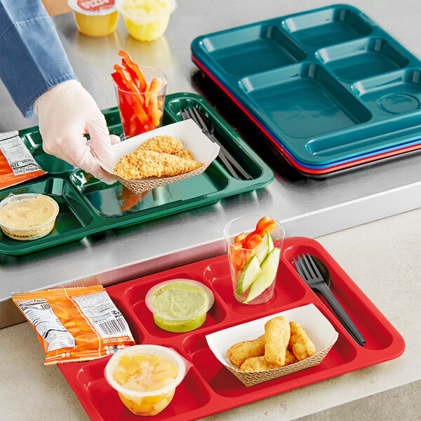 A red Choice heavy-duty melamine compartment tray with food and a plastic fork in it.