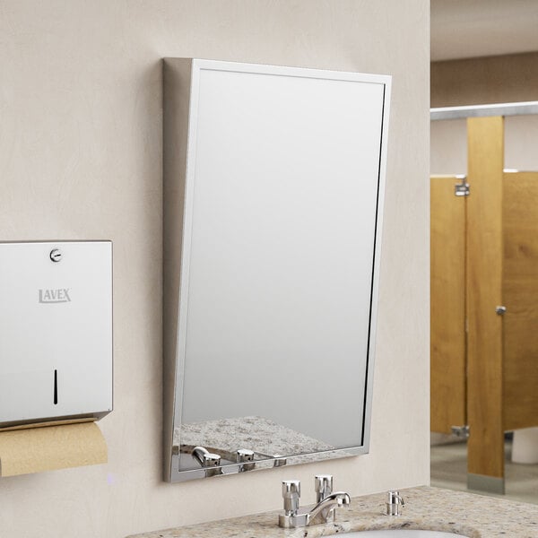 An American Specialties, Inc. stainless steel plate glass mirror above a sink in a commercial bathroom.