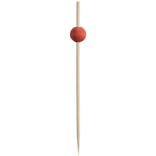A wooden toothpick with a red ball on top.