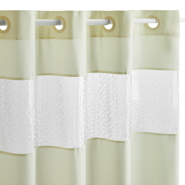 A Hookless beige shower curtain with a white stripe.