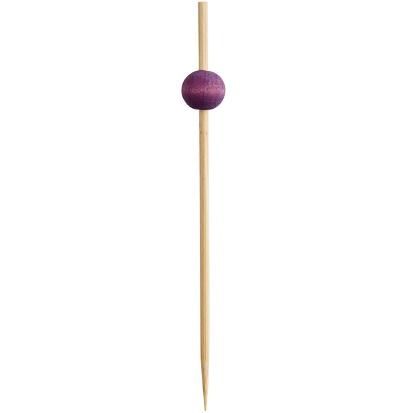 A wooden stick with a purple ball on the end.