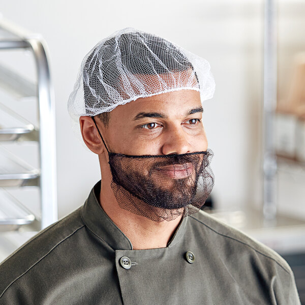 A man wearing a Choice white nylon hairnet cap on his head.