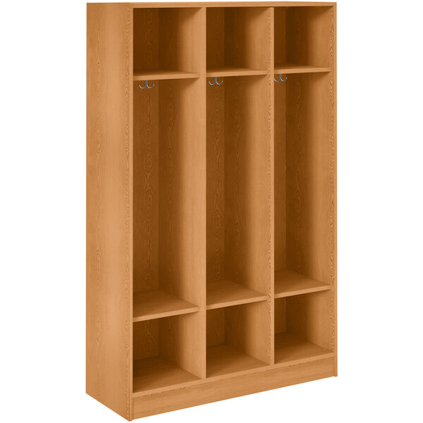 A light oak wooden locker with three shelves and two doors.