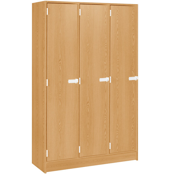 A maple wooden triple door storage locker with shelves.