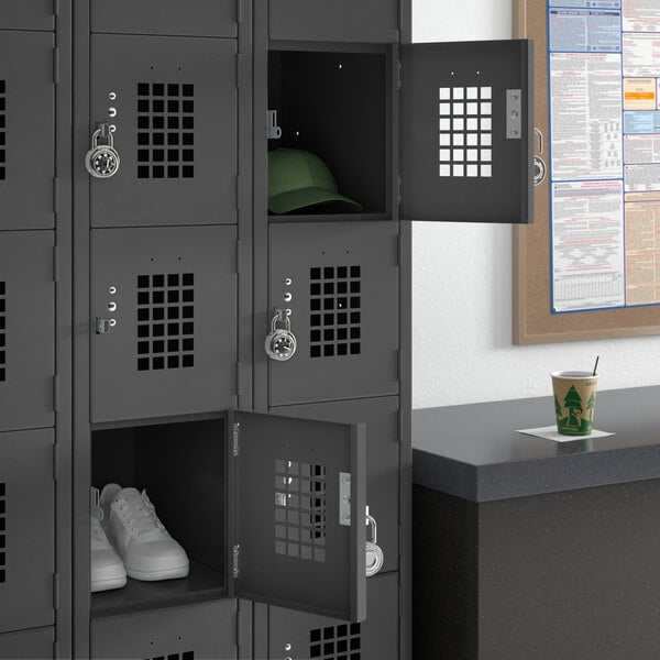 A black Regency 3-wide locker with open doors and shelves with hats and cups.