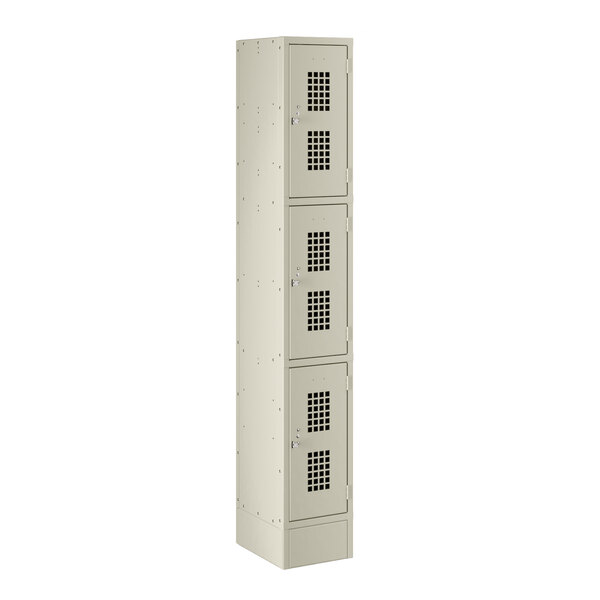 A beige metal Regency locker with three compartments and doors.
