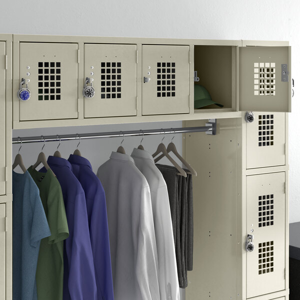 A beige Regency wall mount locker with several shirts hanging inside.