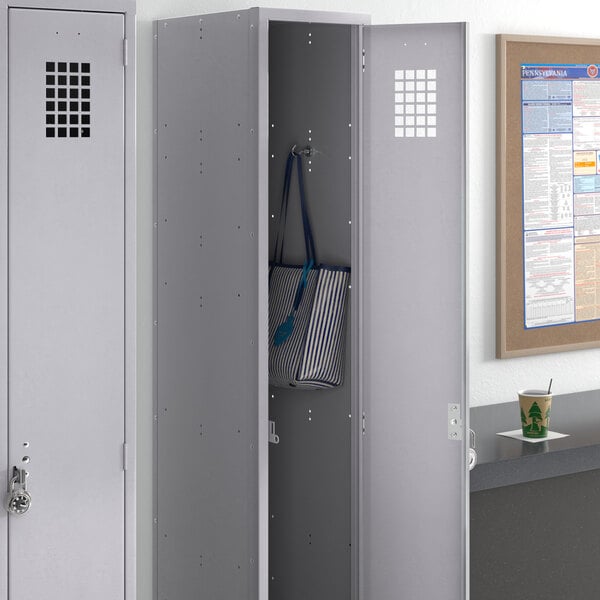 A grey Regency locker with a blue and white striped bag inside.