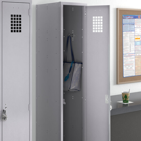 A Regency grey single tier locker with a blue and white striped bag inside.