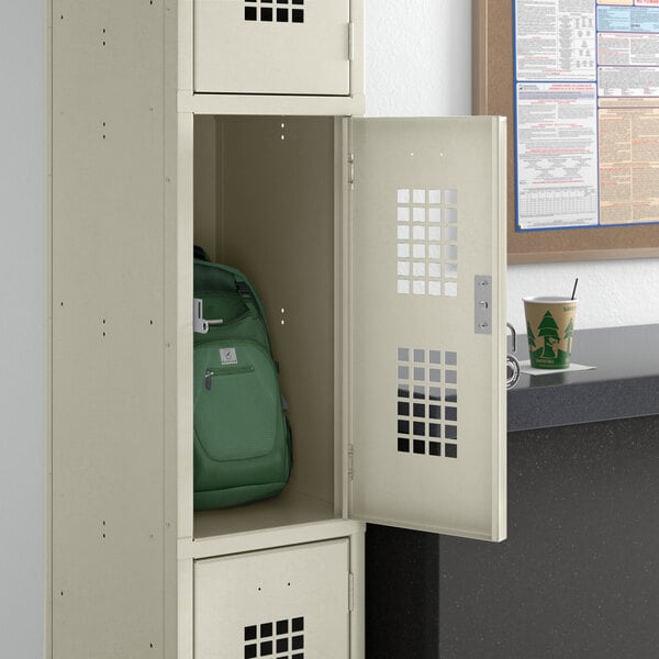 A Regency locker with a green backpack inside.