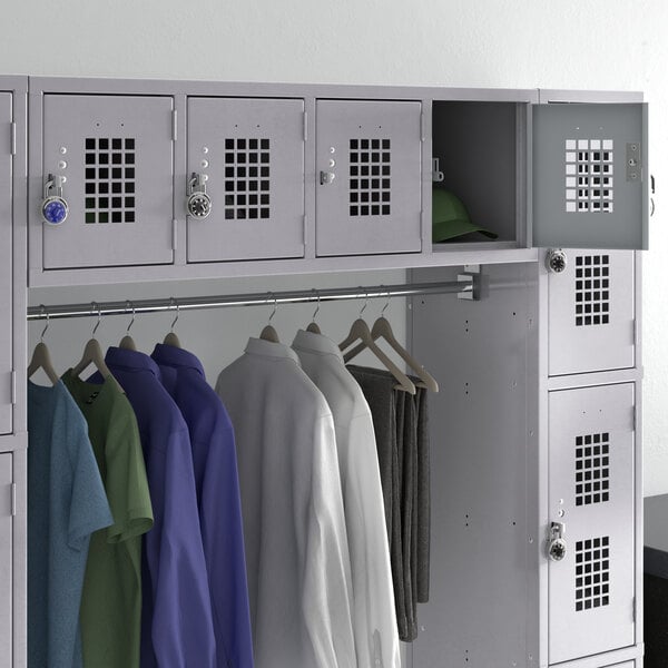 A Regency gray wall mount locker with several shirts hanging in it.