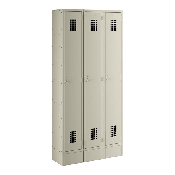 A beige metal locker with three doors and silver handles.