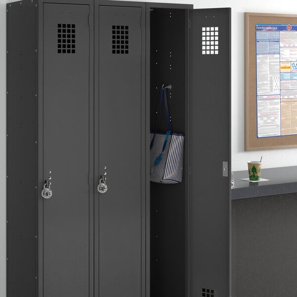 A black Regency locker with three wide lockers in a room.