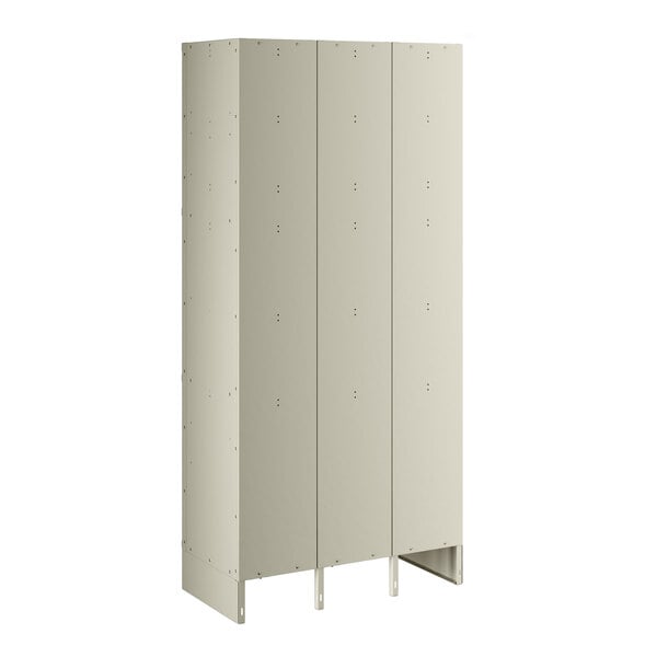 A beige metal locker with three doors and three tiers.