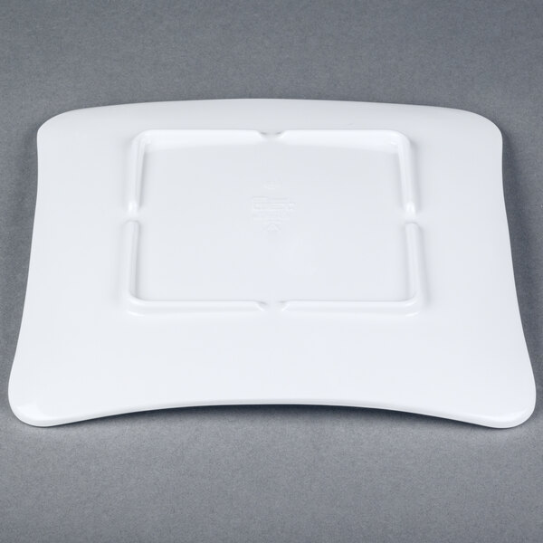A white square plate with a square design.