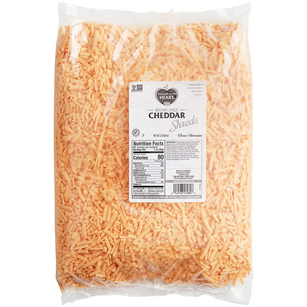 A case of Follow Your Heart Dairy-Free Vegan Shredded Cheddar Cheese on a white background.