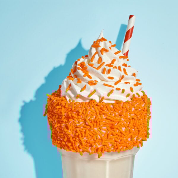 An ice cream cone with Adourne orange sprinkles.