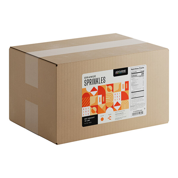 A large cardboard box labeled 'Adourne Orange Sprinkles' containing 10 pounds of orange sprinkles.