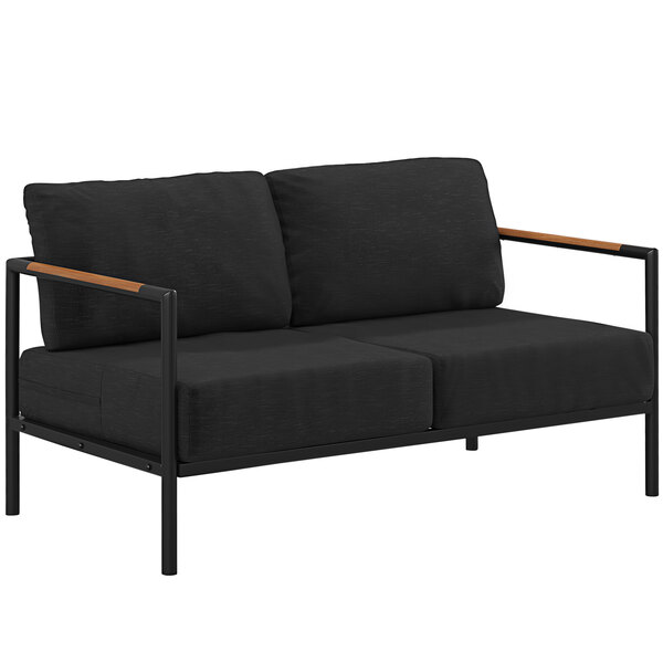 A black loveseat with wooden armrests and teak accents.