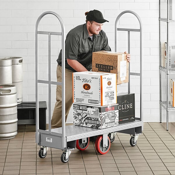 A man pushing a Lavex heavy-duty steel utility cart with boxes.