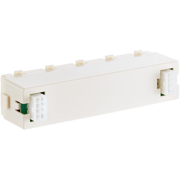 A white rectangular Estella Caffe touch pad control with green and white connectors.