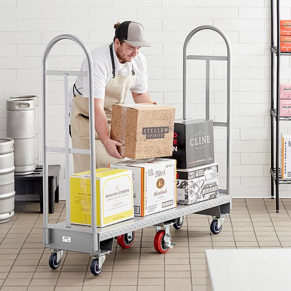 A man in an apron uses a Lavex U-Boat utility cart to carry boxes.