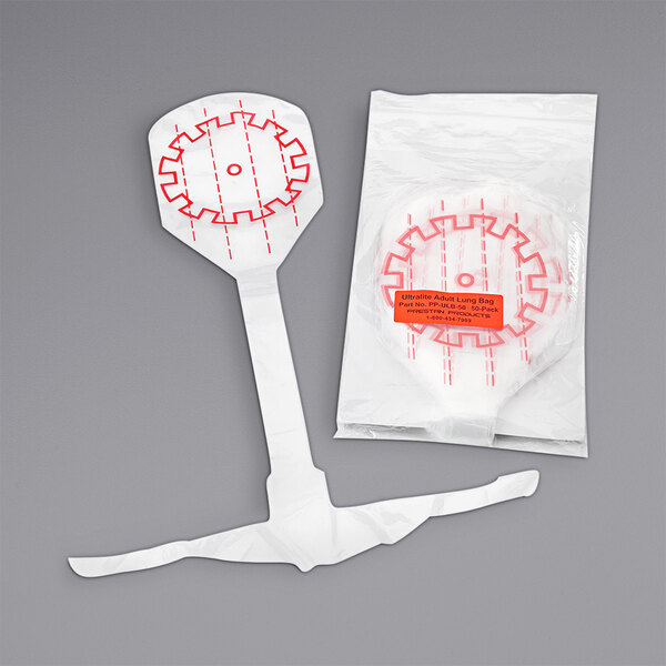 A white plastic bag with red lines and a red design containing Prestan Ultralite CPR manikin lung bags.